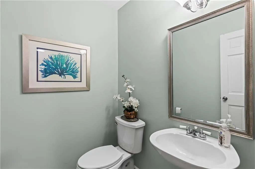 Half bath featuring a sink and toilet