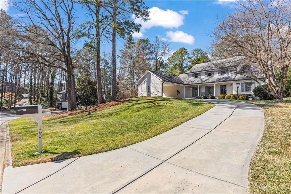 View of front facade featuring driveway and a front yard