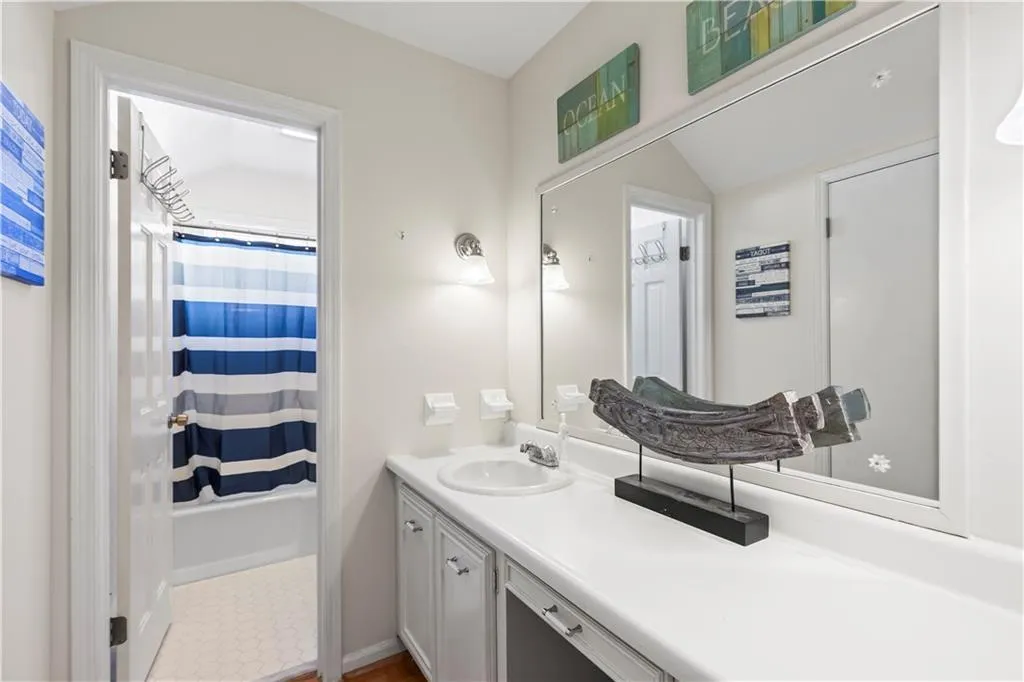 Upstairs Full bath featuring shower / bath combo and vanity