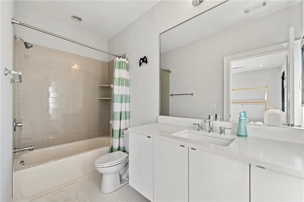 Full bathroom featuring vanity, shower / tub combo, and tile patterned flooring