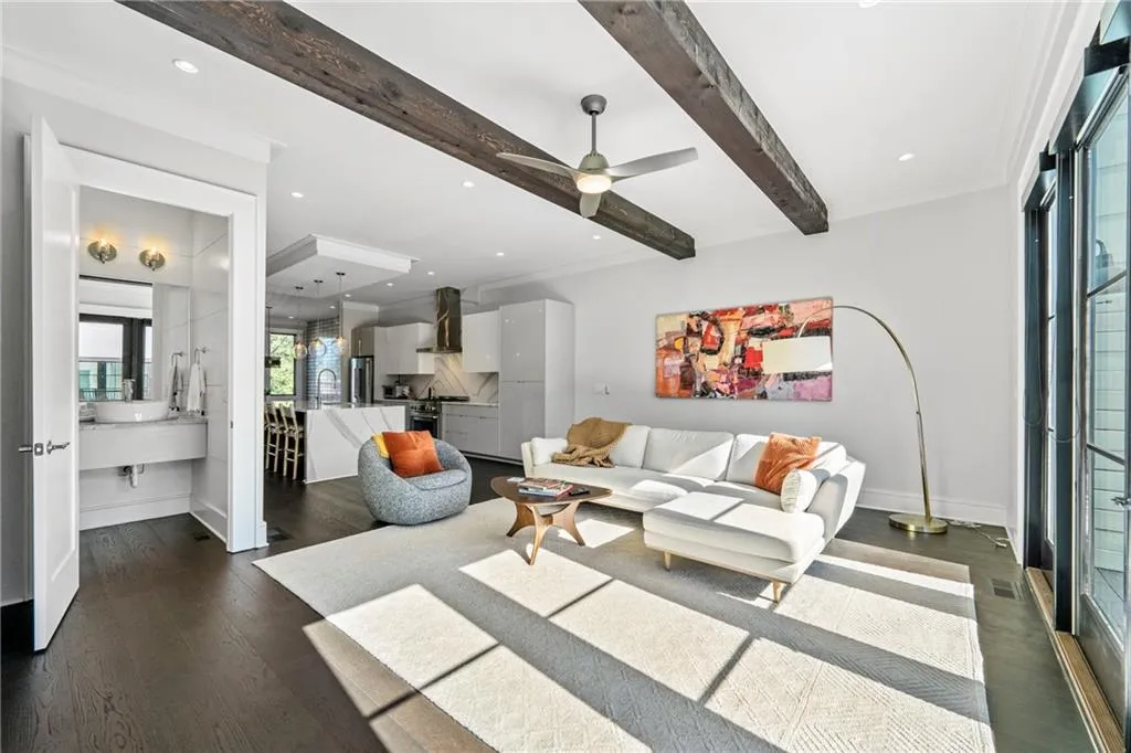 Living room featuring beamed ceiling, recessed lighting, dark wood-style floors, a ceiling fan, and crown molding