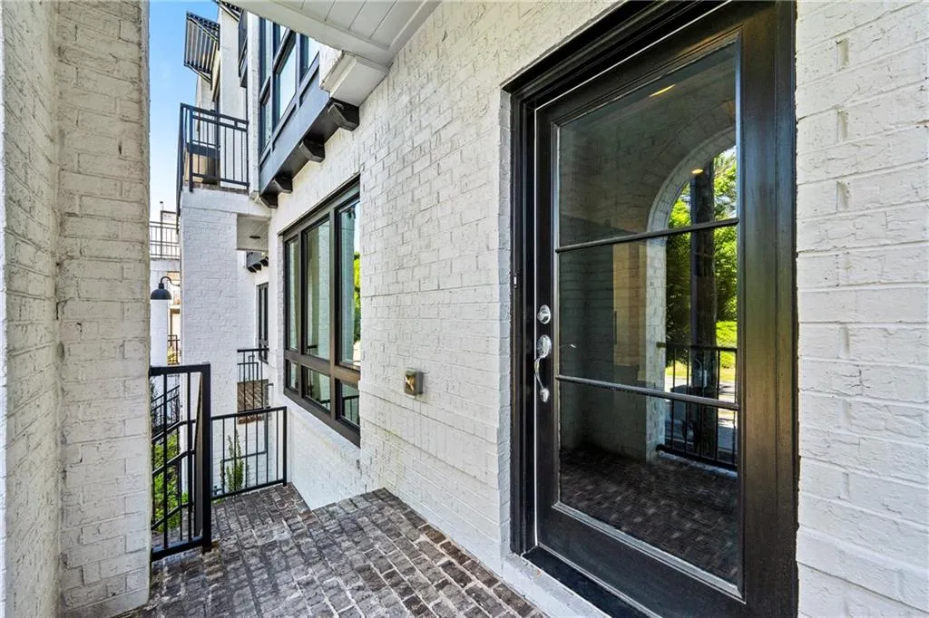 View of exterior entry featuring brick siding