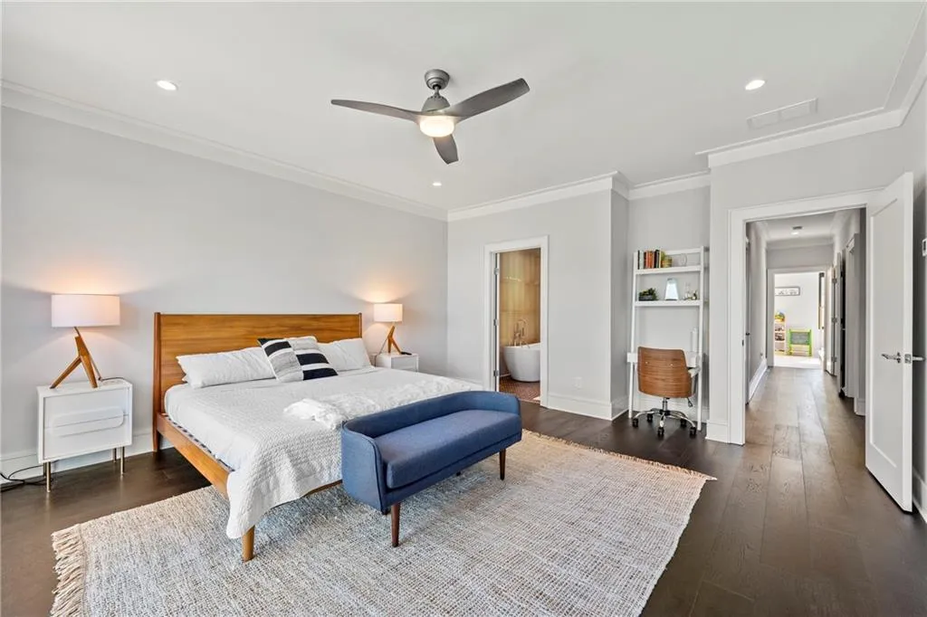 Bedroom featuring a ceiling fan, dark wood-type flooring, recessed lighting, crown molding, and ensuite bath
