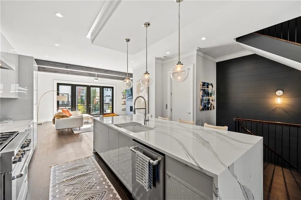 Kitchen with dark wood-style flooring, light stone counters, decorative light fixtures, recessed lighting, and crown molding