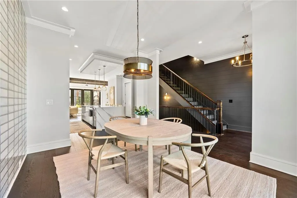 Dining area with a chandelier, stairs, dark wood-style floors, and recessed lighting