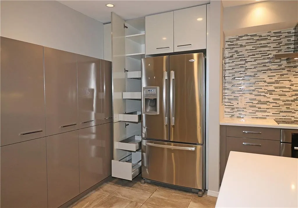 Kitchen featuring stainless steel fridge with ice dispenser, modern cabinets, tasteful backsplash, light tile patterned flooring, and open shelves