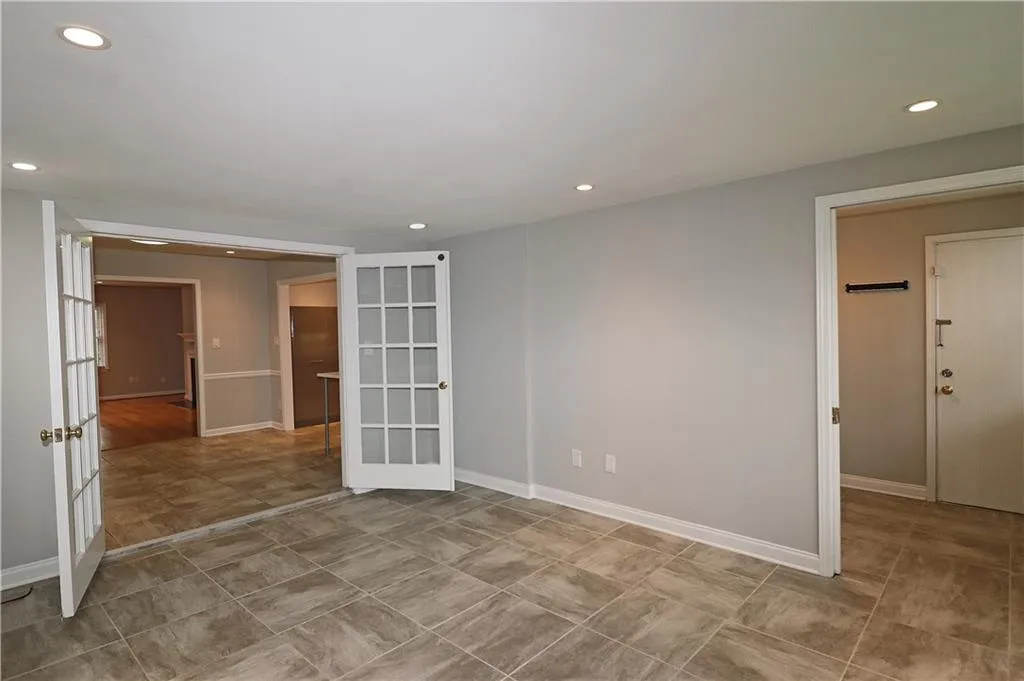 Empty room with recessed lighting and french doors