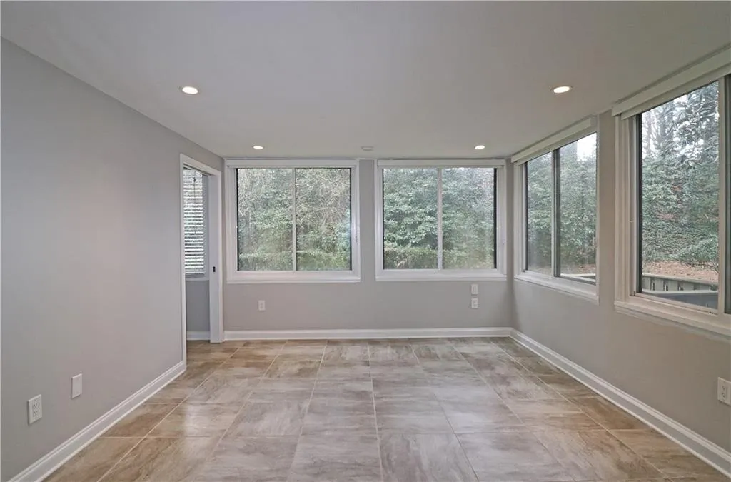 Unfurnished room with baseboards and recessed lighting
