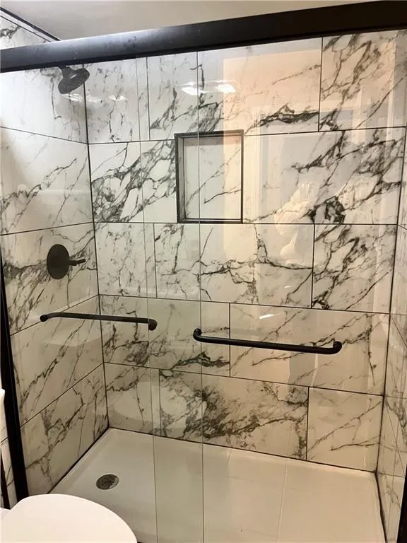 Full bathroom with a stall shower