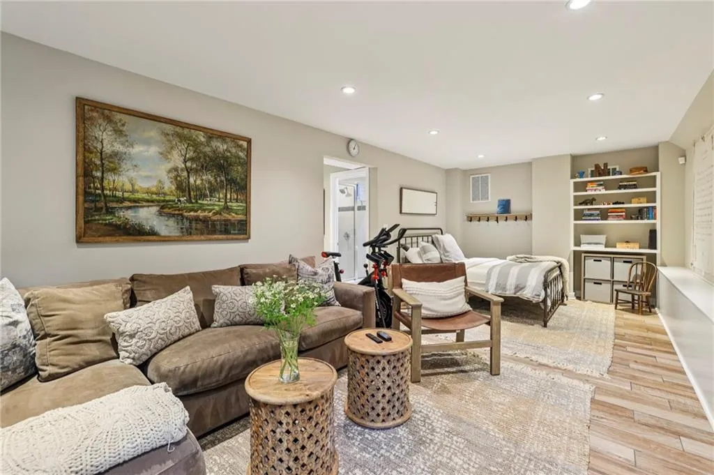 Living room with light wood-style floors and recessed lighting