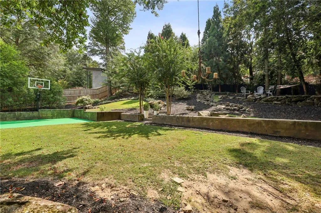 View of yard featuring basketball hoop