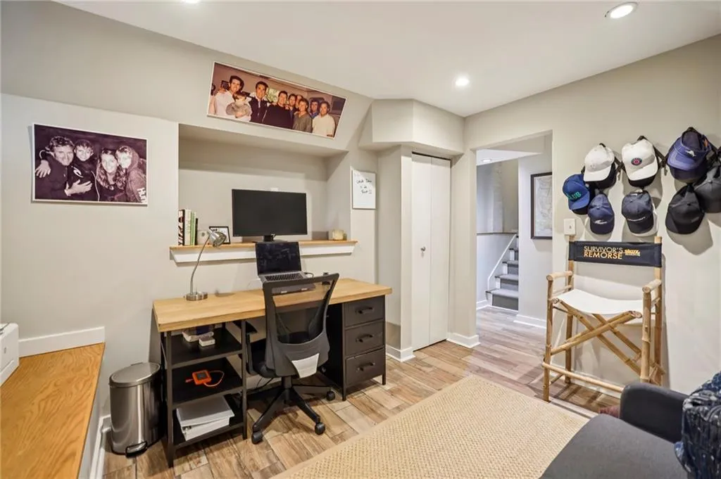 Office space with light wood-style flooring and recessed lighting