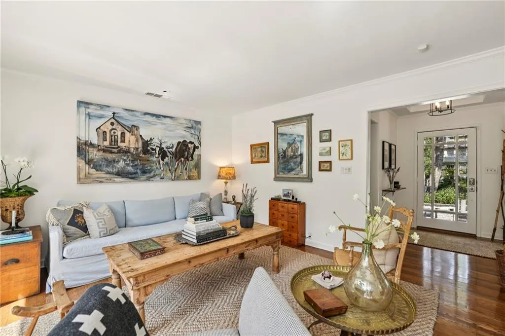 Living room featuring wood finished floors and ornamental molding