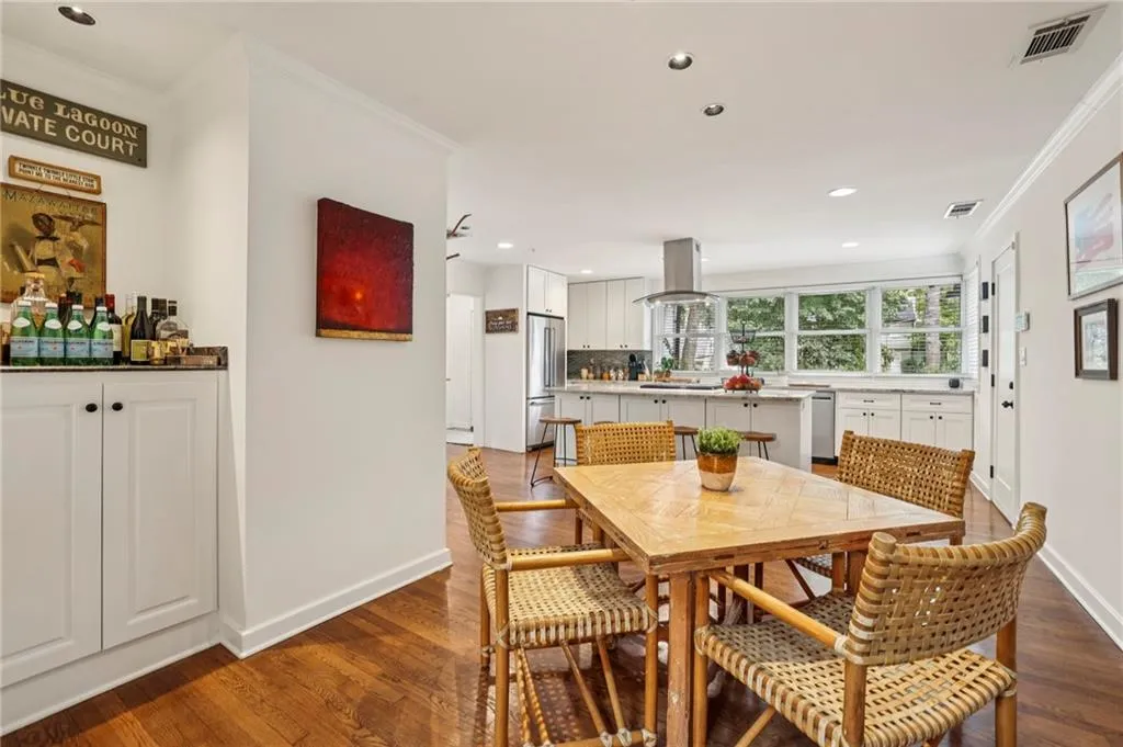 Dining space with crown molding, recessed lighting, and dark wood finished floors