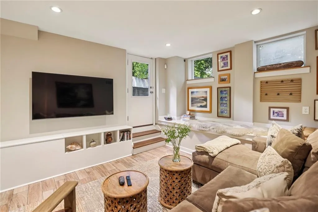 Living room with wood finished floors and recessed lighting