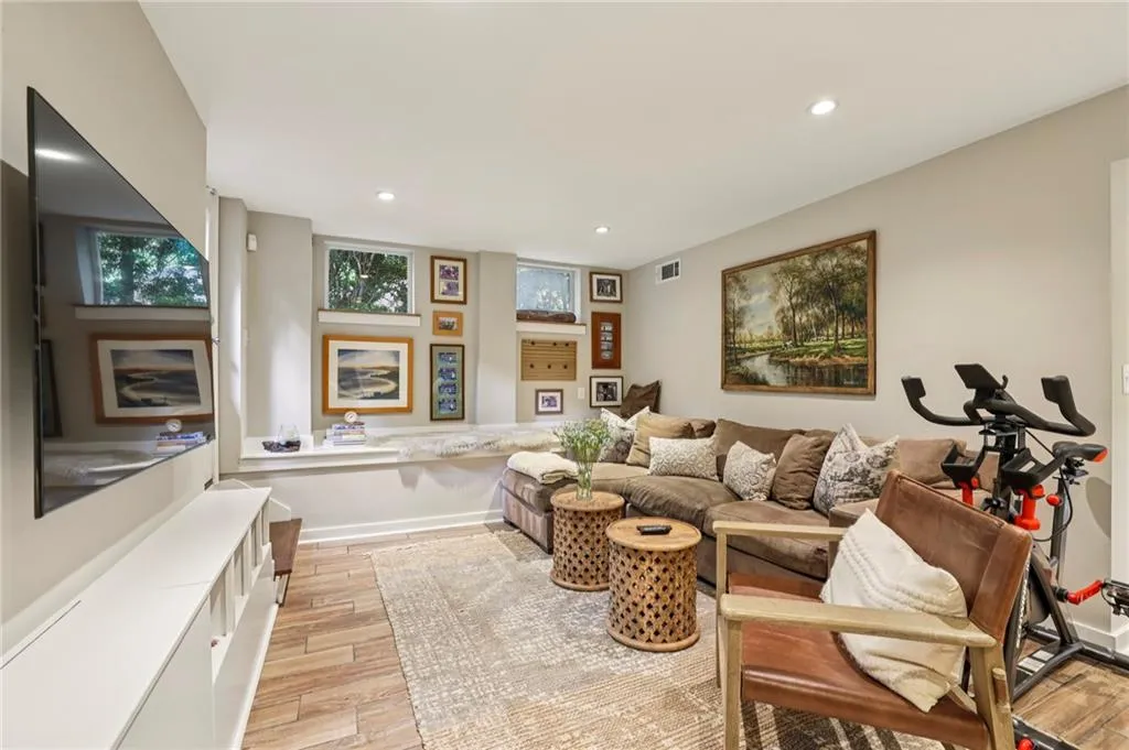 Living room with recessed lighting, light wood-style floors, and plenty of natural light