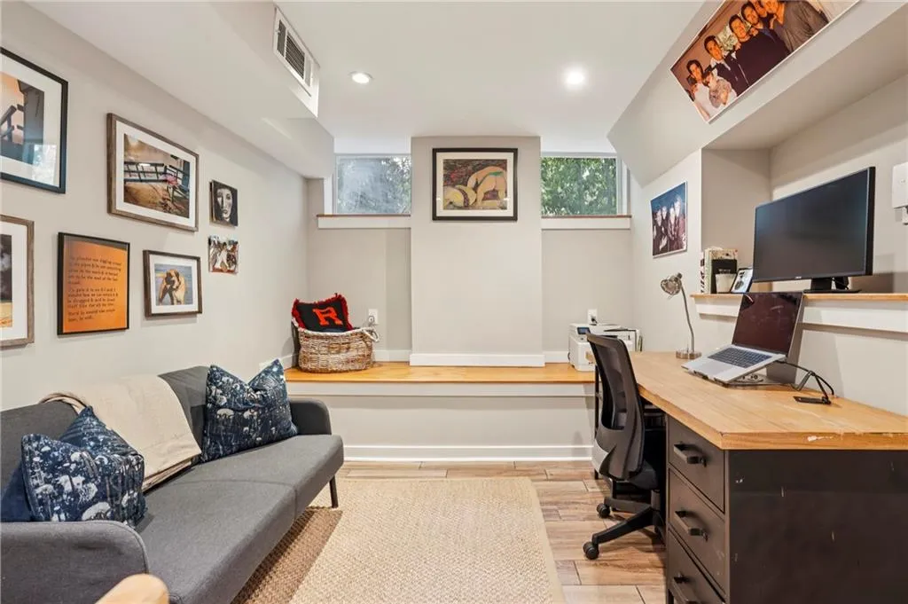 Home office with light wood finished floors, recessed lighting, and built in study area