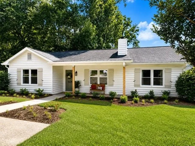 White horizontal siding exterior with a dark gray shingle roof