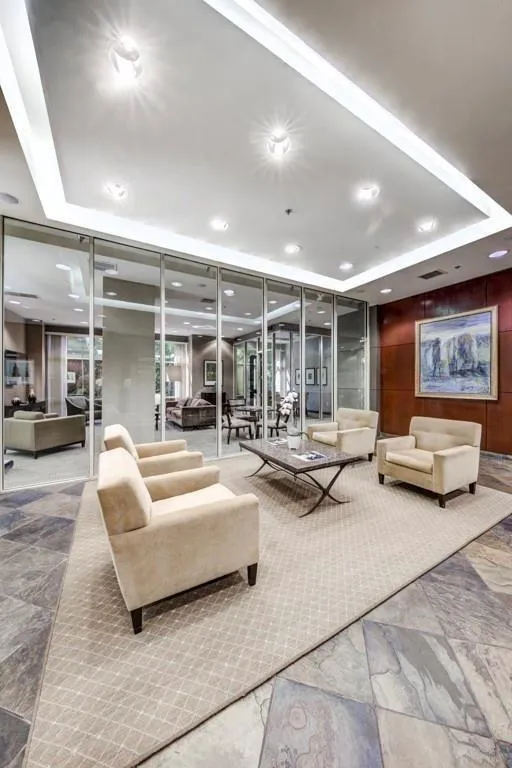 Building lobby featuring recessed lighting, a raised ceiling, and wood walls
