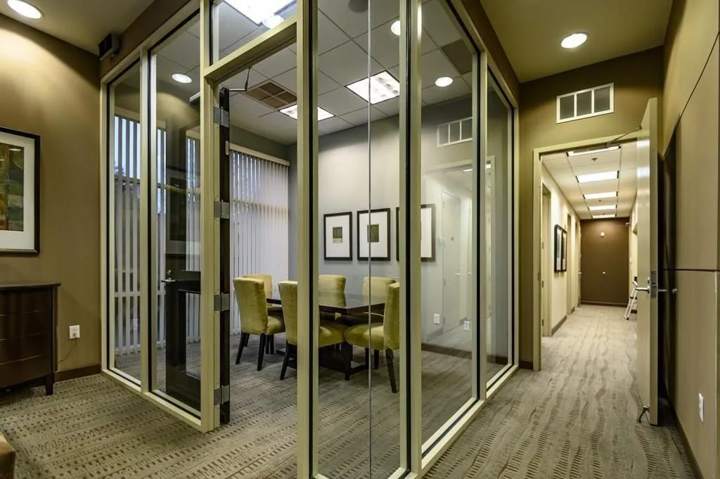 Hall with light colored carpet and recessed lighting