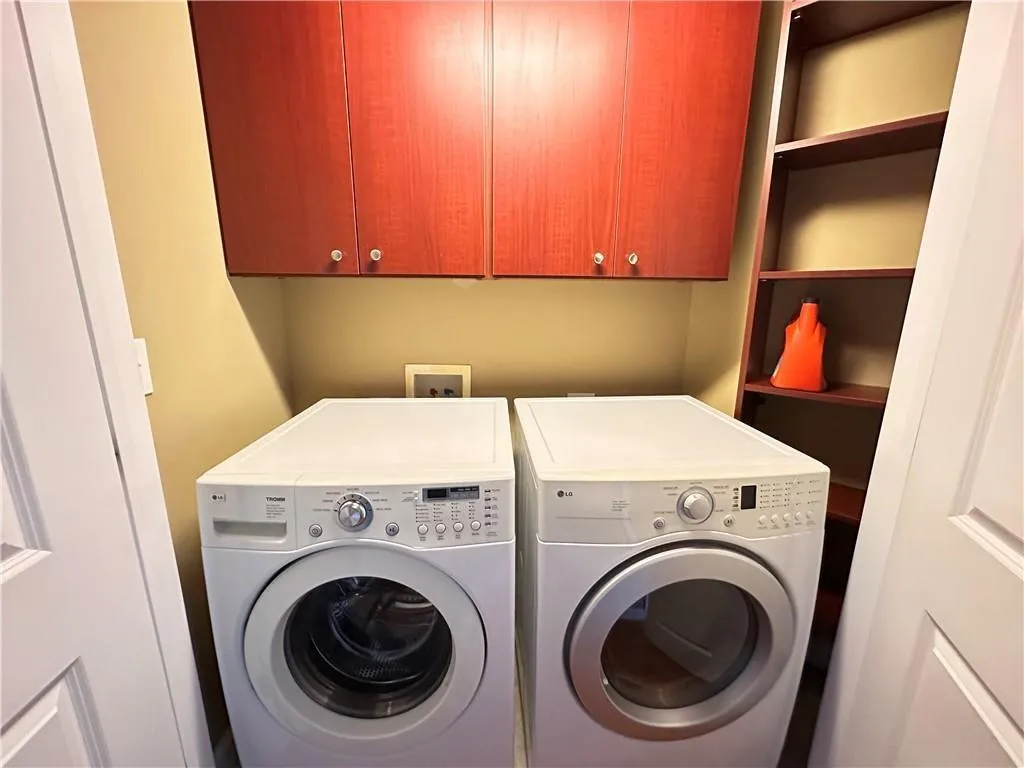 Laundry room featuring cabinet space and washing machine and clothes dryer