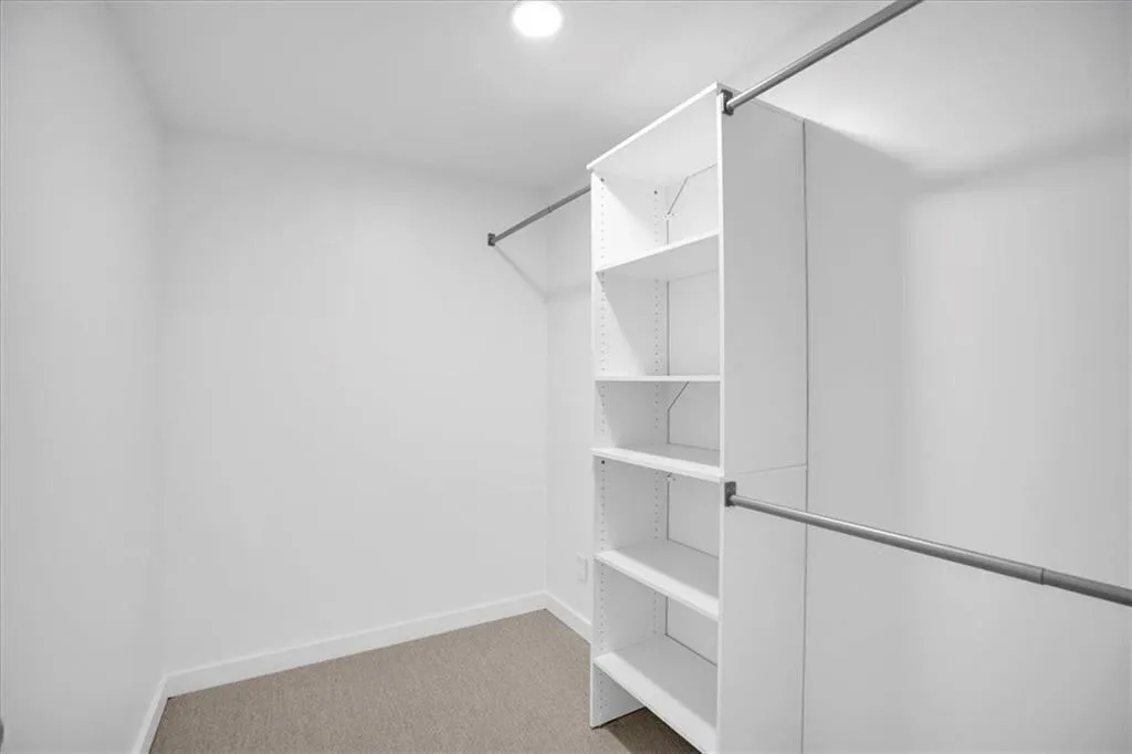 Primary bedroom walk in closet