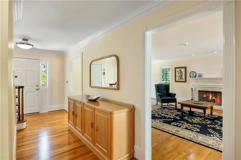 Foyer with baseboards, ornamental molding, light wood finished floors, and plenty of natural light