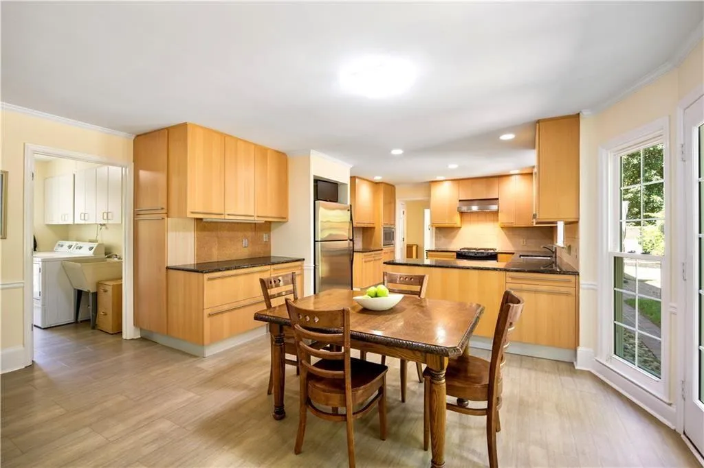 Dining space with recessed lighting, washer / clothes dryer, crown molding, and light wood-type flooring