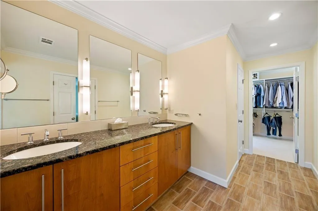 Bathroom featuring recessed lighting, visible vents, baseboards, and a sink