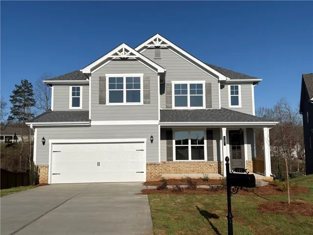 Two-story residence featuring light gray siding with white trim accents and a dark gray shingled roof