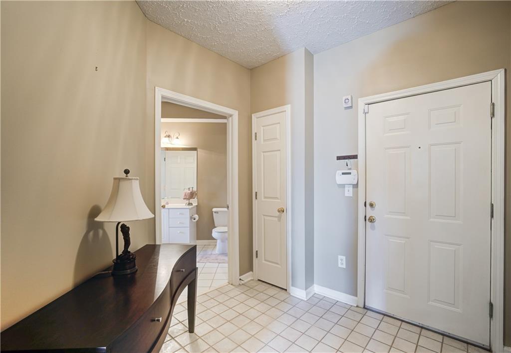Foyer featuring light tile flooring and a textured ceiling
