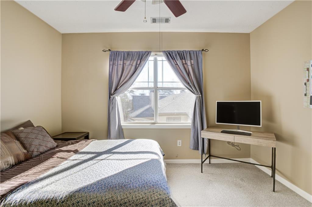 Bedroom featuring light colored carpet and ceiling fan