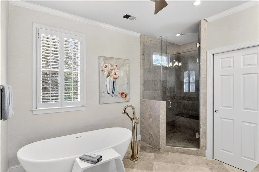 Spa like primary bathroom with separate shower and free standing tub.