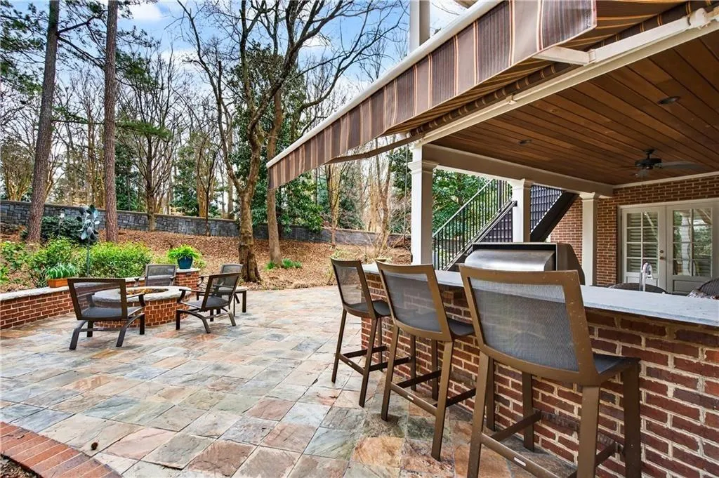 Stone patio, outdoor kitchen, gas fire pit, fully walled and fenced backyard.