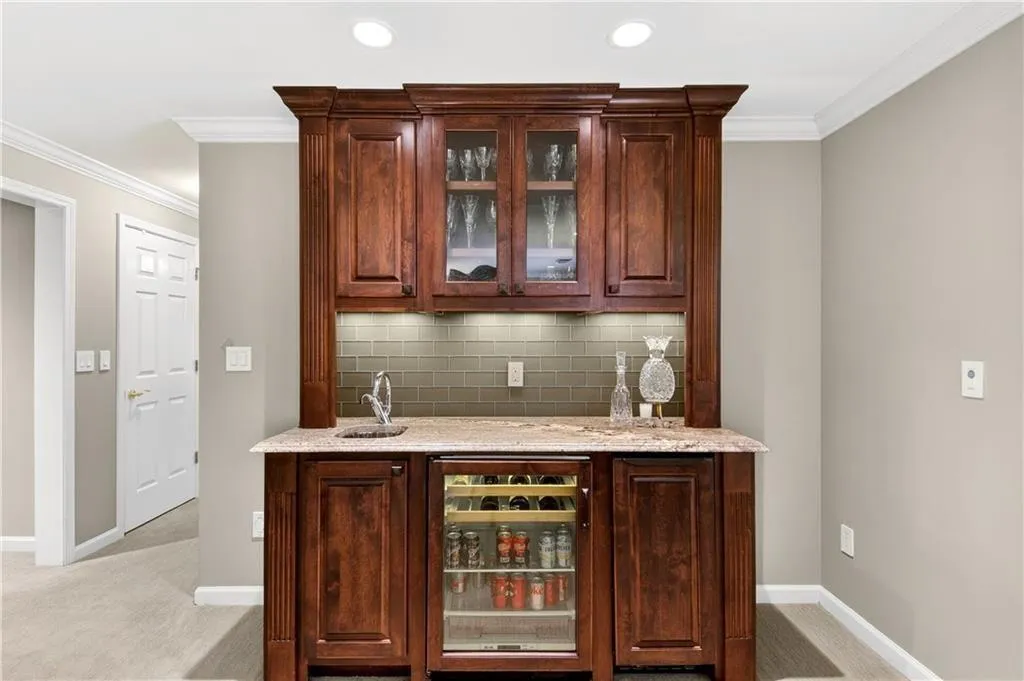 Terrace level wet bar with fridge and wine-cooler.