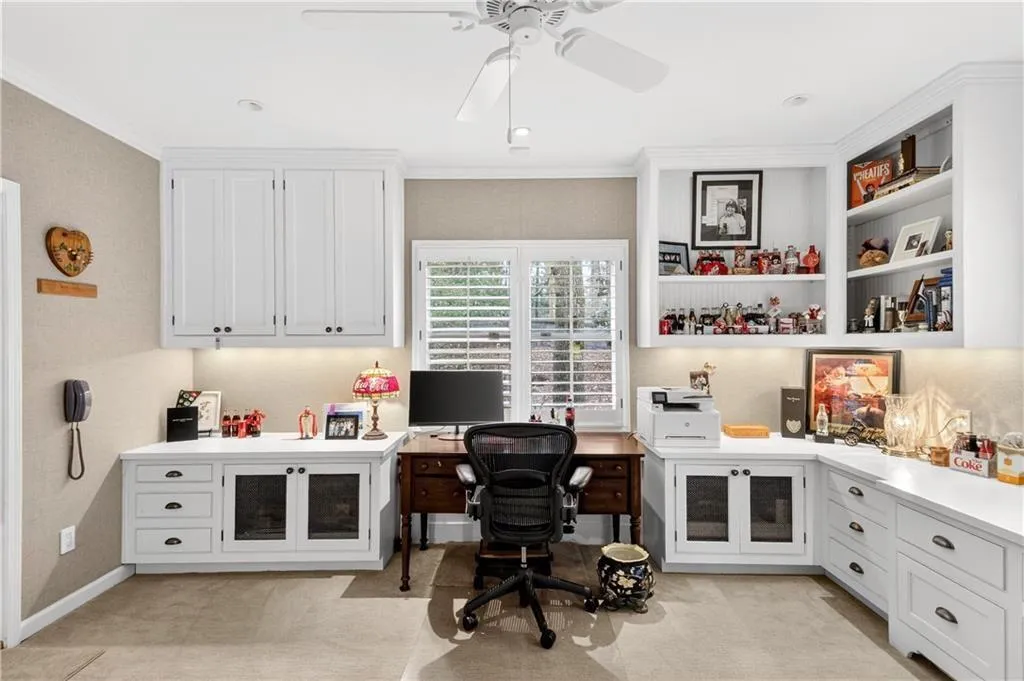 Formal office with built-in cabinets and lots of desk space.