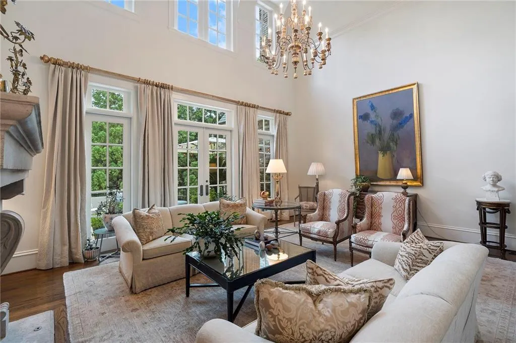 Living room with high ceilings, hardwood flooring, and fireplace