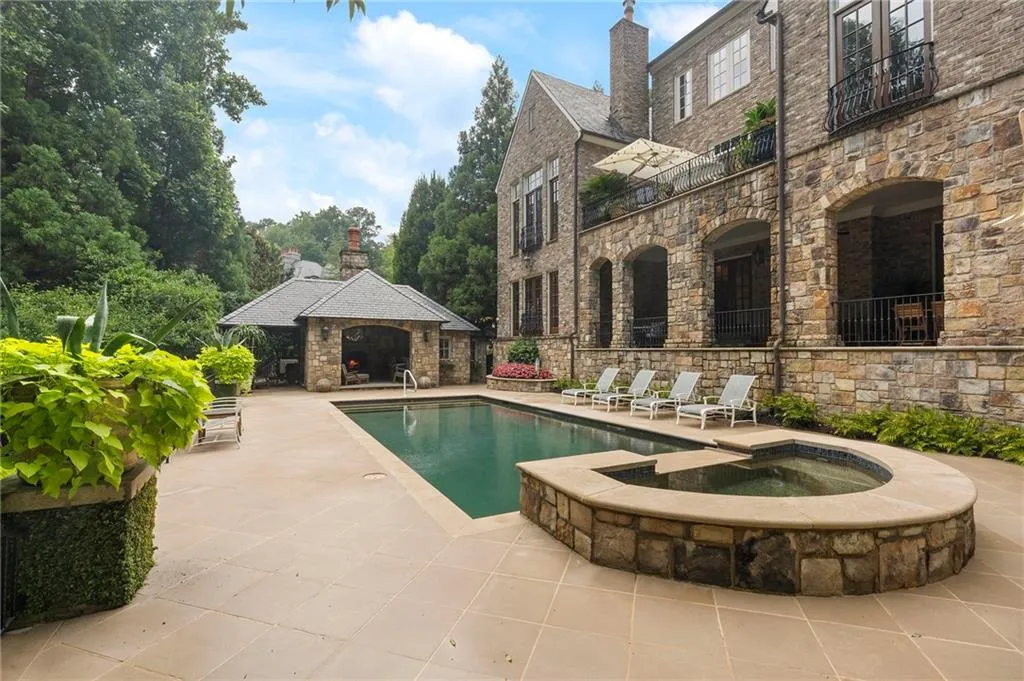 Stone-clad multi-story exterior with an expansive outdoor living area