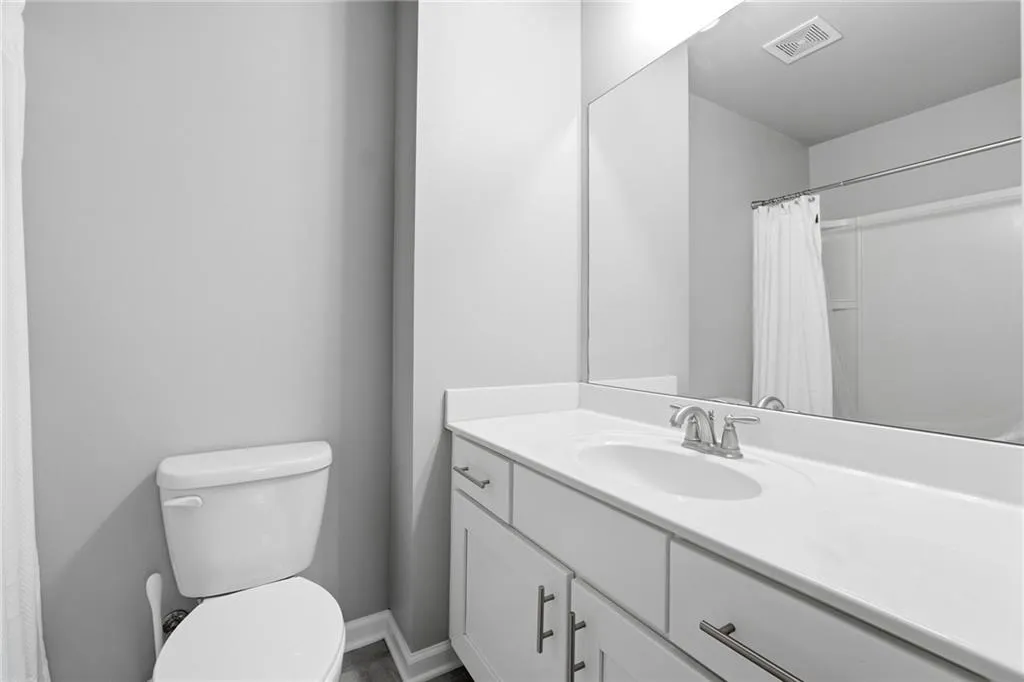 Full bathroom featuring a shower with curtain and vanity
