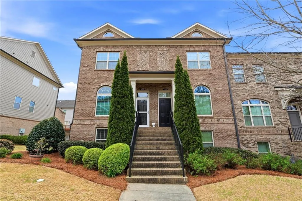 View of front facade featuring brick siding and a front lawn