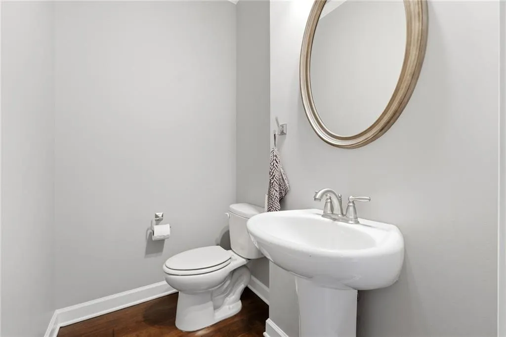 Bathroom featuring baseboards and dark wood-style floors