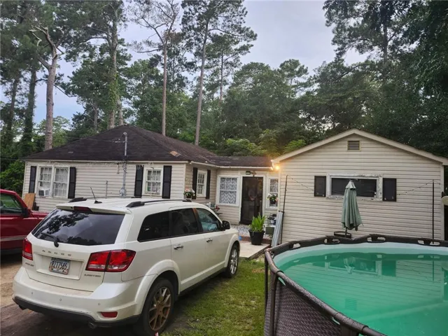 Beige siding exterior with black shutters