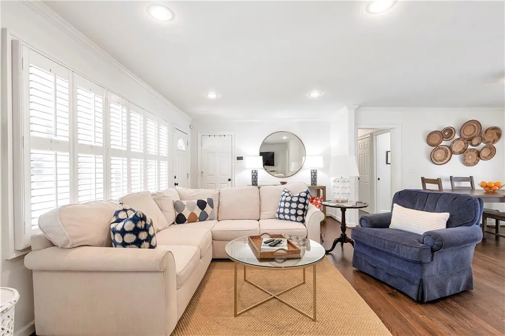 Living room featuring dark wood-type flooring and ornamental molding