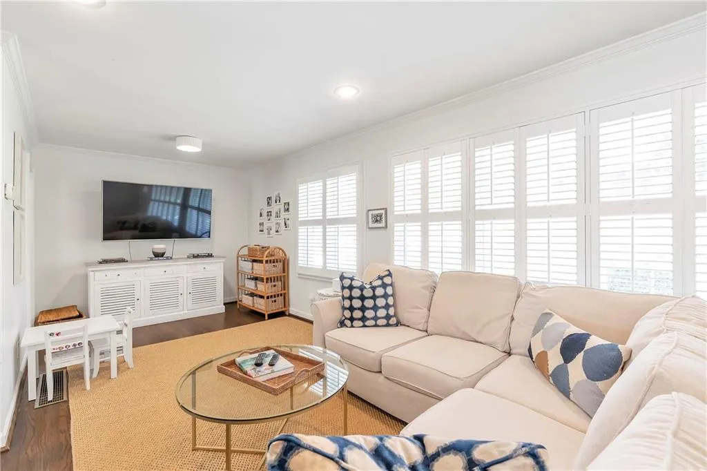 Living room featuring crown molding and dark hardwood / wood-style floors