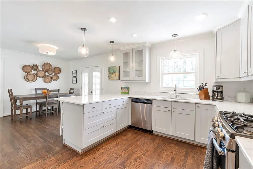 Kitchen featuring white cabinets, dark hardwood / wood-style flooring, sink, and stainless steel appliances