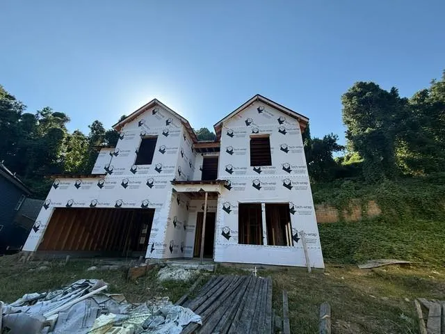New construction framing with dual gables and an integrated garage