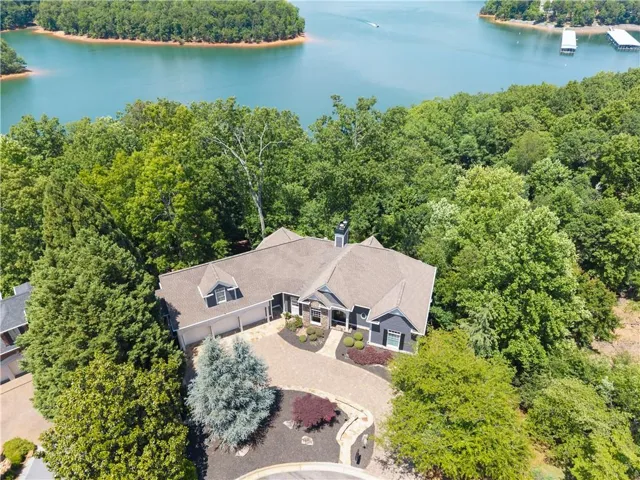 Private waterfront setting tucked into the trees with breathtaking Lake Lanier surroundings.