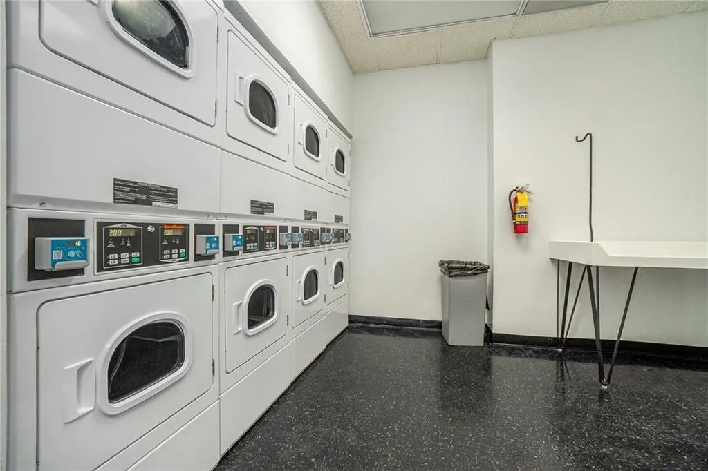Laundry room featuring stacked washer and dryer and washing machine and clothes dryer