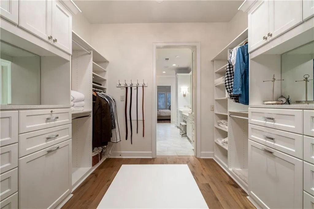 Spacious, Boutique-like Walk in closet featuring light hardwood floors