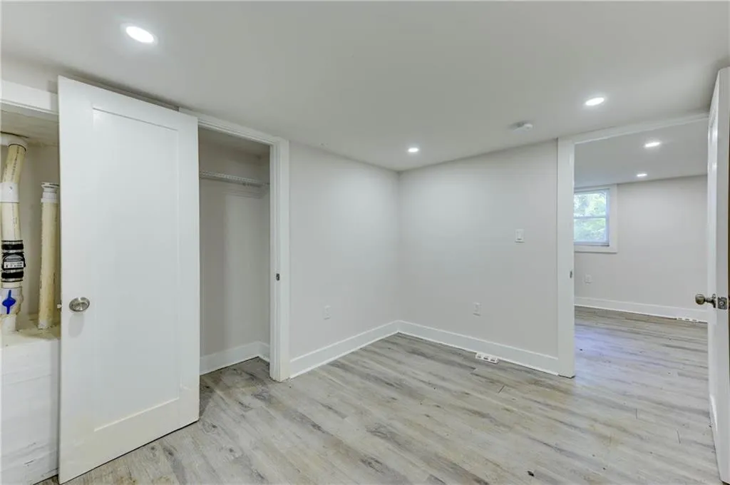 Unfurnished bedroom featuring light wood-style flooring, recessed lighting, and a closet